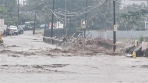 Floodwaters stream down a street in Hauula, Hawaii, on March 9, 2021.Adam Palmer via Reuters.