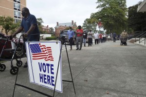 Voters wait in line to cast their ballot during early voting at the Bell Auditorium in Augusta, Ga.