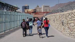 Migrants who had been in Mexico under the Migrant Protection Protocols, or the "Remain in Mexico" program, enter the United States at the Paso del Norte Bridge in El Paso, Texas, on March 10, 2021.