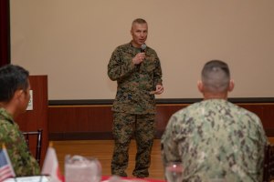 Marine Corps Col. Christopher J. Bronzi, center, commanding officer of 15th Marine Expeditionary Unit, gives his remarks during the closing ceremony for Exercise Iron Fist 2020.