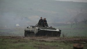 Service members of the Ukrainian armed forces drive an armored vehicle during training at a firing range in the Donetsk region, Ukraine, on April 20, 2021.
