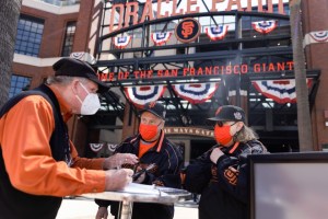 San Francisco Giants fans Dave Harding of San Leandro, center,