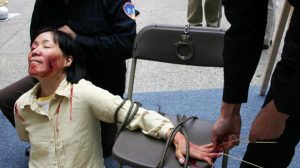 Reenactment of one of the brutal torture methods employed by the CCP officials to coerce female Falun Gong adherents to renounce their faith.