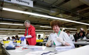 Election workers with vote-by-mail ballots for the Washington presidential primary, Renton, Wash., March 10, 2020.
( Jason Redmond/Getty)