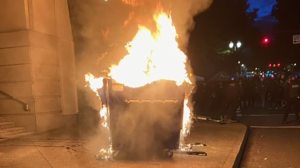 Marchers in Portland on Tuesday lit a dumpster on fire. (Portland police)