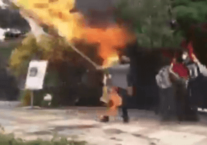 Man caught on fire while burning an Israeli flag. (Twitter screenshot)