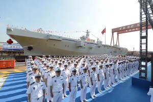 China's People's Liberation Army Navy (PLAN) sailors stand before the first Type 075 class of amphibious assault ship, Sept. 25, 2019.