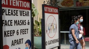 Customers wear face masks in an outdoor mall with closed businesses amid the COVID-19 pandemic in Los Angeles, June 11, 2021. (Associated Press)
