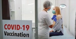 A woman receives the CCP Virus vaccine in Bakersfield, Calif., on April 27, 2021,