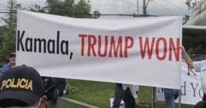 Protesters holding up a up sign saying “Trump won” waited for Vice President Kamala Harris outside Guatemala’s presidential palace.