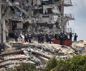 Members of the South Florida Urban Search and Rescue team look for possible survivors in the partially collapsed 12-story Champlain Towers,