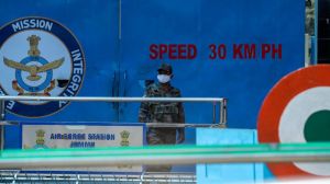 An Indian army soldier stands guard at the main gate of Jammu air force station after two suspected blasts were reported early morning in Jammu, India, (AP Photo/Channi Anand)