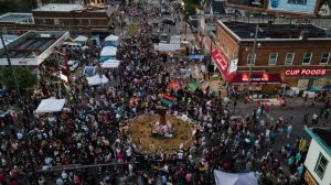 In a photo taken with a drone, people gather at George Floyd Square on the one-year anniversary of Floyd's death, Tuesday, May 25,