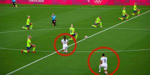 Women's soccer players from the United States (white) and Sweden (yellow) take a knee before their opening-round game at the Tokyo Olympics on Wednesday. (Photographer: Noriko Hayashi/Bloomberg via Getty Images)