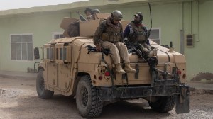Members of Afghan Special Forces climb down from a humvee as they arrive at their base after heavy clashes with Taliban during the rescue mission of a police officer besieged at a check post, in Kandahar province, Afghanistan, July 13, 2021. REUTERS/Danish Siddiqui