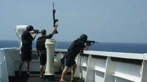 These British maritime security guards are "showing weapons" to ward off pirates from the bridge of a merchant tanker.