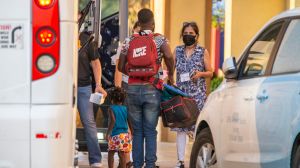 Volunteers with Faith Forward Dallas help migrant families from Haiti and Cuba exit a coach bus at a hotel in Irving, Wednesday, August 11, 2021.(Brandon Wade / Special Contributor)