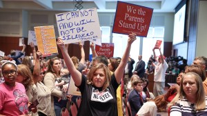 Shelley Slebrch and other angry parents and community members protest after a Loudoun County School Board meeting was halted by the school board because the crowd refused to quiet down, in Ashburn, Virginia, U.S.  June 22, 2021. REUTERS/Evelyn Hockstein