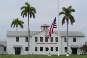 In this photo reviewed by U.S. military officials, a flag flies at half-staff in honor of the U.S. service members and other victims killed in the terrorist attack in Kabul, Afghanistan, at Marine Corps Security Force Company, Friday, Aug. 27, 2021, in Guantanamo Bay Naval Base, Cuba.