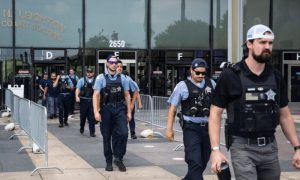 Dozens of Chicago police officers and personnel walk out of the Leighton Criminal Courthouse after attending the bond hearings for two brothers charged in connection with the fatal shooting of Officer Ella French, Tuesday, Aug. 10, 2021,