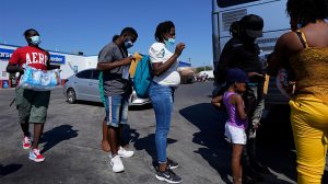 In this Sept. 20, 2021, file photo, migrants, many from Haiti, board a bus after they were processed and released after spending time at a makeshift camp near the International Bridge in Del Rio, Texas. (AP Photo/Eric Gay, File) (AP Photo/Eric Gay, File)