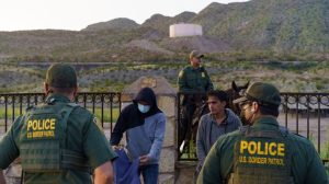 Illegal migrants, who were detained trying to cross into the United States undetected, wait to be searched by United States Border Patrol agents in Sunland Park, N.M., on Sept. 1, 2021. (Paul Ratje/AFP via Getty Images)