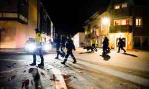 Police with dogs patrol the centre of Kongsberg, Norway, after the attack on Wednesday night. Photograph: Hakon Mosvold Larsen/EPA