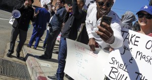 Siaka Massaquoi, right, listed on IMDb as an actor, was one of the demonstrators who protested the vaccine clinic at Dodger Stadium on Jan. 30.(Irfan Khan / Los Angeles Times)