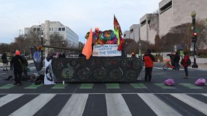 Activists block streets near the U.S. Capitol in Washington on Dec. 7, 2021.   (BRENDAN SMIALOWSKI/AFP via Getty Images)