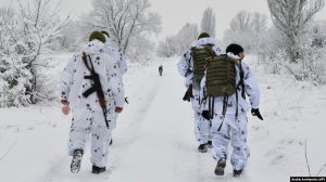 Ukrainian servicemen walk to their position at the front line with Russia-backed separatists outside the village of Verkhnotoretske in the Donetsk region of eastern Ukraine on December 27.