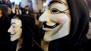 A protester wearing a Guy Fawkes mask, symbolic of the hacktivist group "Anonymous," takes part in a protest in central Brussels.   (REUTERS/Yves Herman/File Photo)