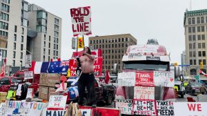 A Freedom Convoy demonstrator holds a "Hold The Line" sign while dancing in Ottawa, Canada (Fox News Digital/Lisa Bennatan)