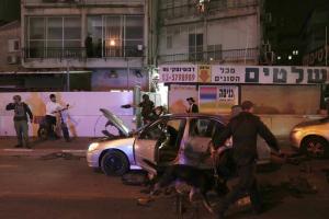 Israeli police search a car at the scene of a shooting attack in Bnei Brak, Israel, Tuesday, March 29, 2022.(AP Photo/Oded Balilty)