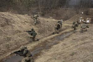Ukrainian soldiers of the 103rd Separate Brigade of the Territorial Defense of the Armed Forces, fire their weapons, during a training exercise, at an undisclosed location, near Lviv, western Ukraine, Tuesday, March 29, 2022. (AP Photo/Nariman El-Mofty)