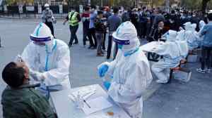 Residents line up at a makeshift COVID-19 testing site in Shanghai. (cnsphoto via Reuters)