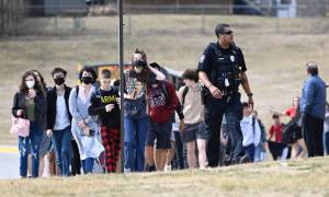 Students from Olathe East High school are led off buses to reunite with their parents Friday at Pioneer Trail Middle School in Olathe after a shooting at the high school. Reed Hoffmann SPECIAL TO THE STAR