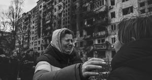 A woman reacts as she stands outside destroyed apartment blocks following shelling in the northwestern Oblonsky district of Kyiv on Monday. (Aris Messinis/AFP/Getty Images)
