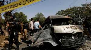 
Police officers and crime scene unit gather near a passenger van, after a blast at the entrance of the Confucius Institute University of Karachi, Pakistan April 26, 2022. Photograph:( Reuters )