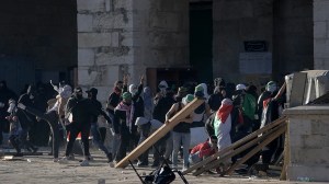 Palestinians clash with Israeli security forces at the Al Aqsa Mosque compound in Jerusalem's Old City Friday, April 15, 2022. (AP Photo/Mahmoud Illean)