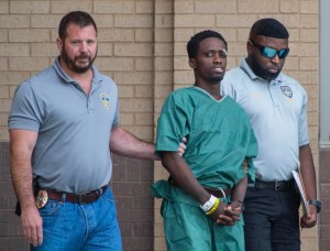 Baton Rouge Police Cpl. Reese Jenkins, left, and Cpl. Russell Williams, right, escort a suspect, Earl Lee Johnson, Jr., 35, center,Tuesday, April 19, 2022. STAFF PHOTO BY TRAVIS SPRADLING