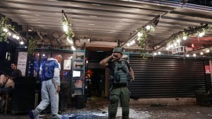 Israeli police inspect the scene of a shooting attack In Tel Aviv, Israel on Thursday. Israeli police say several people were wounded in a shooting in central Tel Aviv. The shooting on Thursday evening occurred in a crowded area with several bars and restaurants. (AP/Ariel Schalit)