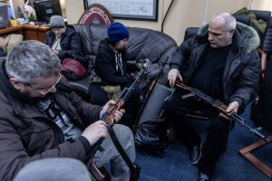 Civilian volunteers check their guns at a TDF unit registration office on Feb. 26 in Kyiv. (Chris McGrath/Getty Images)