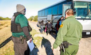 Border Patrol agents apprehend illegal immigrants after they cross the Rio Grande from Mexico into the United States, in La Joya, Texas, on Jan. 14, 2022. (Charlotte Cuthbertson/The Epoch Times)