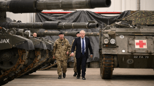 British Prime Minister Boris Johnson is shown around the Royal Tank Regiment Battlegroup by Lt. Col. Simon Worth after a joint press conference at the Tapa Army Base, in Tallinn, Estonia, on March 1.