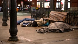 People sleep outside on a sidewalk on April 6, 2020 in Seattle. (Photo by Karen Ducey/Getty Images) (Karen Ducey/Getty Images)
