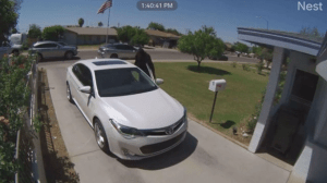 Surveillance footage shows an Arizona man robbing an elderly woman at gunpoint in her driveway after following her home. (Fox 10 Phoenix)