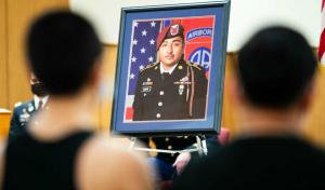 Friends of Spc. Enrique Roman-Martinez sit silently during his memorial ceremony. (Master Sgt. Alexander Burnett/82nd Airborne Division/TNS)