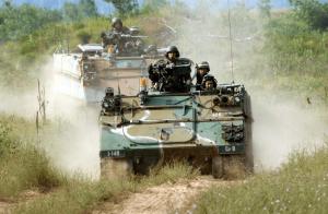 An M113 Armored Personnel Carrier moves into position during a platoon live-fire exercise at Camp Grayling Mich., July 2005. (Ohio Army National Guard Historical Collections/Released)