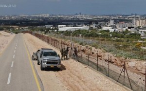 Security forces work to repair holes in the West Bank security barrier on April 13, 2022. (Defense Ministry)