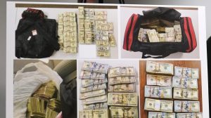 Evidence photographs showing bundles of currency at the Moakley Federal Courthouse in Boston, on May 24, 2022. (Charles Krupa/AP Photo)